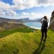 Woman hiking in high mountains near Haukland Beach in beautiful Lofoten, Nordland, Norway Woman hiking in high mountains near Haukland Beach in beautiful Lofoten, Nordland, Norway